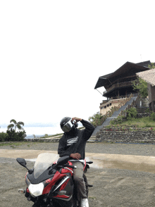 a man sitting on a motorcycle wearing a black shirt that says ' i 'm a motorcycle ' on it