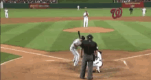a baseball game is being played in a stadium with a washington nationals logo in the outfield
