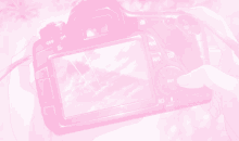 a pink background with a person holding a camera with the off and on buttons