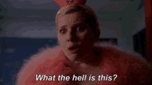 a woman in a pink fur coat and bunny ears is crying and saying `` what the hell is this ? ''