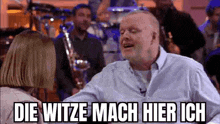 a man is talking to a woman in front of a band and says `` die witze mach hier ich ''