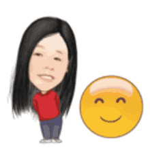 a woman in a red shirt is standing next to a yellow smiley face .