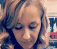 a close up of a woman 's face with her eyes closed and her hair blowing in the wind .