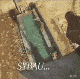 an aerial view of a swimming pool with the word sybau written on the bottom