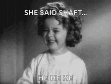 a little girl is laughing in a black and white photo .