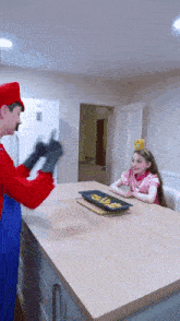a man dressed as mario is playing with a little girl