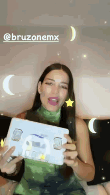 a woman in a green tank top is holding a white box with a plane on it