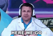 a man in a lab coat is wearing headphones and says here we go .