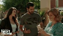 a man and two women are standing next to each other with the words super channel heart & name on the bottom right