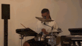 a man playing drums in front of a keyboard that says yamaha