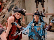 a man and a woman in pirate costumes are posing for a photo