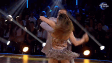a man and a woman are dancing in front of a dancing brasil sign