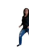 a woman in ripped jeans and a black shirt is dancing