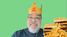 a man wearing a yay king crown giving a thumbs up