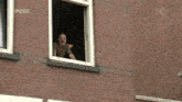 a brick building with a sign that says ' veldhoven college '