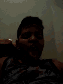 a young boy is sticking his tongue out while wearing a shirt that says ' avengers ' on it