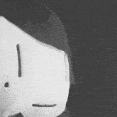 a black and white photo of a stuffed animal with a surprised face