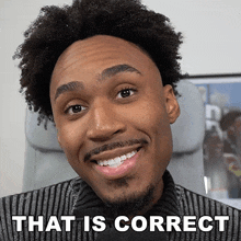 a man with curly hair and a beard smiles with the words that is correct behind him