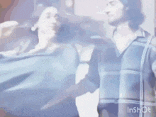 a man and a woman are standing next to each other and dancing .