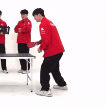 a man in a red jacket with the word faker on his back