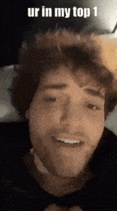 a close up of a man 's face with the words ur in my top 1 above it