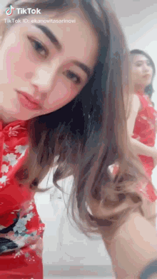 a woman is taking a selfie with a tiktok id