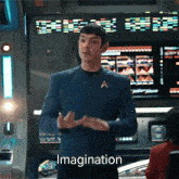 a man in a star trek uniform says imagination in front of a computer screen