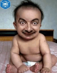a baby in a diaper is sitting on a bed with a big smile on his face .