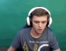 a man wearing headphones and a t-shirt is dancing .