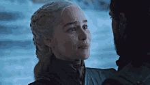 a man and woman are looking at each other and the woman is smiling