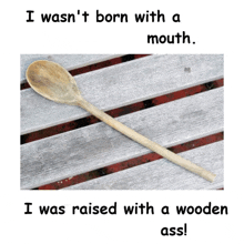 a wooden spoon sits on a wooden table with the words i was raised with a wooden ass written below it