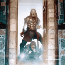 a man in armor is standing next to a man in a hood