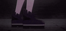 a girl is standing in front of a building with a sword in her hand in a dark room .