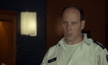 a man in a police uniform has a name tag that says ' smith '