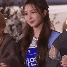 a young woman wearing a blue shirt with the number 9 on it