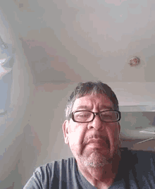 a man wearing glasses and a beard is looking at the camera