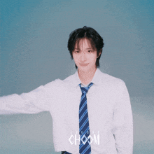 a young man wearing a white shirt and tie with the word choom on the front