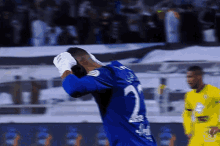 a man wearing a blue jersey with the number 7 on it