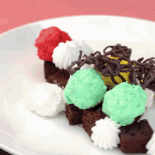 a white plate topped with a variety of colored frosting