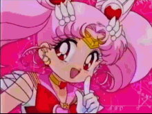 a girl with pink hair and a crown on her head is giving a thumbs up