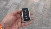 a person is holding a car key in their hand with youtube.com/namastecar at the bottom