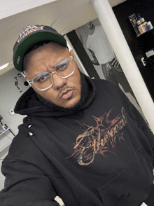 a man wearing a black hoodie with the word eternal on the front