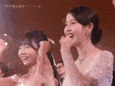 a woman in a white dress holds another woman 's hand