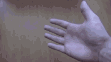 a person is putting their finger on another person 's wrist