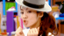 a woman wearing a hat with the letter l on the bottom