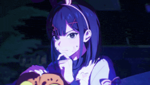 a girl with a bunny ear headband is holding a cookie in her hand