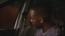 a man is sitting in the back seat of a car and smiling