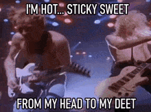 a man playing a guitar with the words i 'm hot sticky sweet from my head to my deet below him