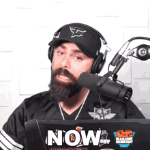 a man with a beard is wearing headphones and a hat that says fs on it