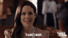 a woman says i can 't wait in front of a heart & home logo
